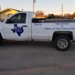 RJT white pickup truck blue on the side of the truck